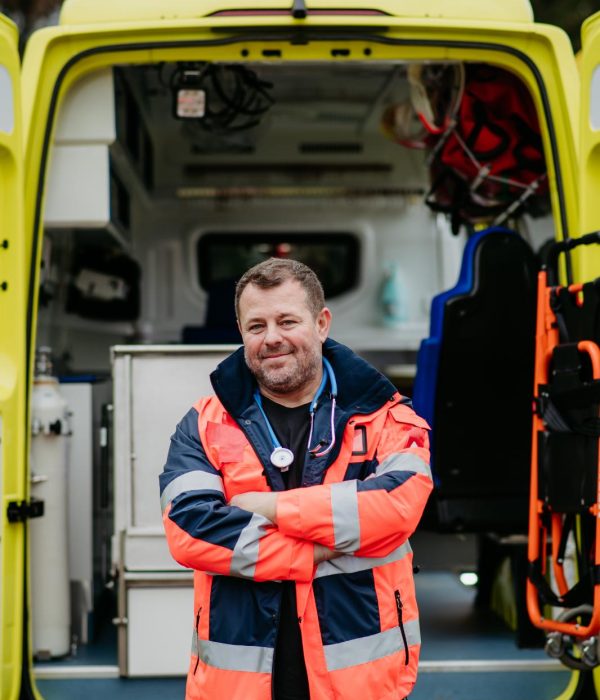 portrait-of-doctor-standing-in-front-of-ambulance-2023-11-27-04-58-26-utc